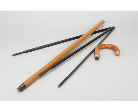 A Walking Stick Tripod and Three Walking Sticks, a black, lightweight metal tripod contained in a hollow curved-handle wooden