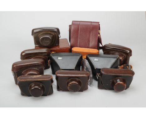 Leitz Camera Cases, seven camera cases, brown leather, with film reminder cut-outs, together with two black ever ready camera