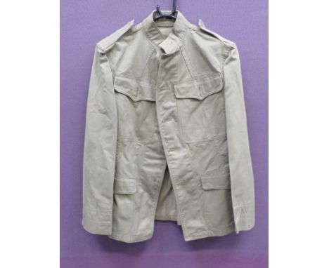 WW1 American Tropical Tunickhaki green drill, single breasted, high collar tunic.  Plain chest patch pockets with buttoned fl