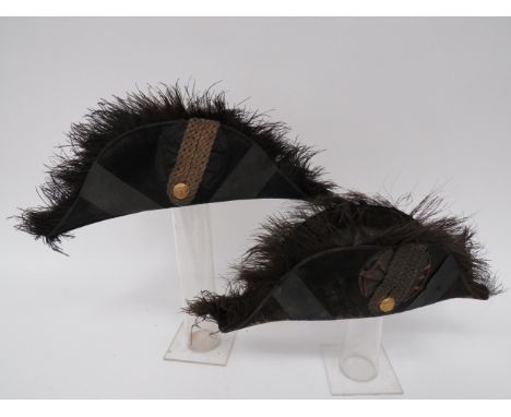 Two Post 1901 Court Bicornsblack beaver, flat folding bicorn with black silk edging.  Black ostrich feather edging.  The cent