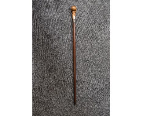 A 1920s cane or swagger stick having hallmark for Chester to cuff, with carved hand holding ball to handle.