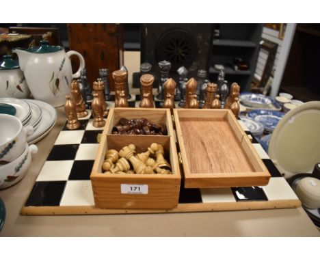 A ceramic chess board and chess pieces also included is a box of wooden chess pieces.