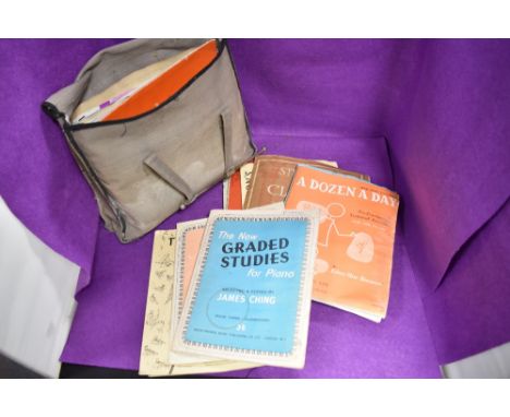 A bag of vintage sheet music and books.