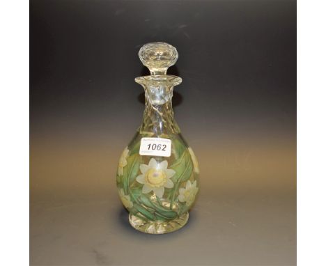 An early 20th century ovoid decanter, boldly painted with water lily flowers and leaves, faceted neck, conforming stopper, 23