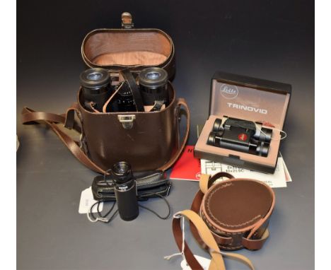 A pair of Carl Zeiss binoculars, Dialyt 10 x 40 B, made in West Germany, cased; a pair of Leitz binoculars, trinovid BC + BCA