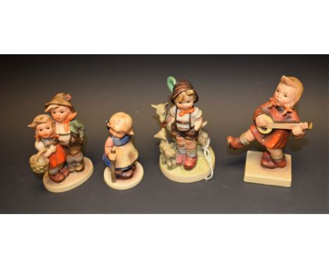 A collection of four Goebel Hummel figures