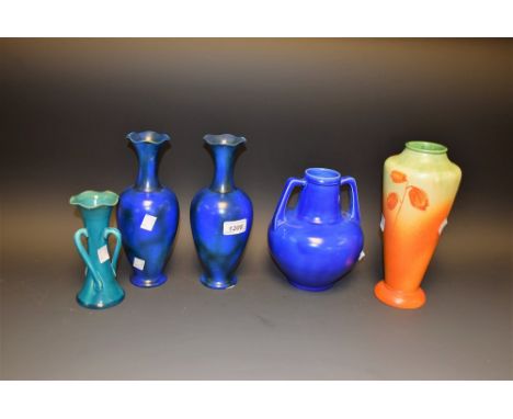 A pair of Bretby early 20th Century flared neck vases, peacock blue glaze; a Bretby twin handled urn vase, blue glaze; an Art