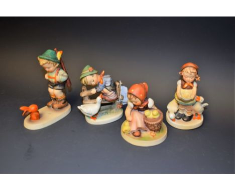 A collection of four Goebel Hummel figures