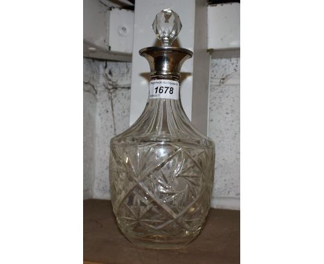 A cut glass decanter, silver rim, London 1963