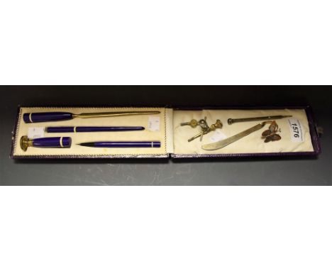An Art Deco bakelite desk suite, cased; a Victorian white metal propelling pencil; etc 
