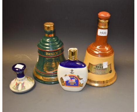 A Bells ceramic whisky decanter; another, similar, green; a Wade miniature  Pussers Rum decanter; another similar (4)