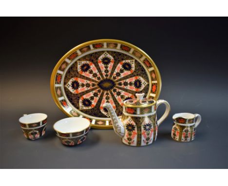 A Royal Crown Derby 1128 miniature tea set comprising teapot, sugar bowl, cream jug, cup and serving tray