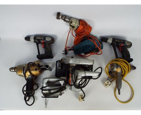 A mixed power tool lot to included drills, a planer. a circular saw and similar.