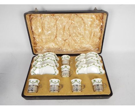A silver and ceramic Aynsley six person tennis set comprising six cups with silver cup holders, Birmingham assay 1910 and six