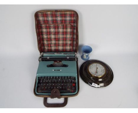 Lot to include an Olivetti Lettera 22 portable typewriter, polished granite cased barometer and Wedgwood beaker. [3]