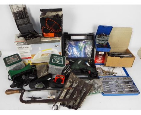 Various mixed tools and a boxed steam iron.