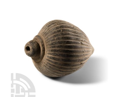 9th-11th century A.D. Piriform body with vertical ribbing along the whole length, domed filler-hole, intended to be filled wi