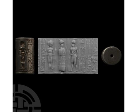 19th-16th century B.C. Haematite with a standing naked female facing frontally, a male worshipper wearing long robes and cap,
