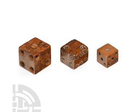 12th-16th century A.D. Graduated set of three dice, each cuboid with ring-and-dot markings disposed 1:6, 2:5, 3:4.  2.2 grams