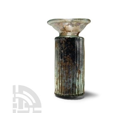 1st-4th century A.D. Comprising an iridescent glass tubular body with vertical ribbing reminiscent of an architectural column