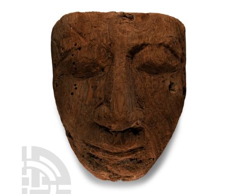 Late Period, 664-332 B.C. D-shaped in plan with carved facial detailing, thick nose and full lips; pierced in four places for