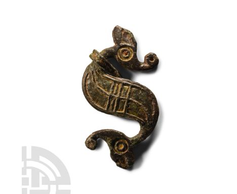 75-175 A.D. S-shaped dragonesque brooch with comma-shaped finials, each with a raised ring-and-dot 'eye', curved neck, body w