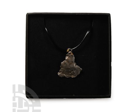Fell 6000-5000 years B.P. Comprising a section of nickel-iron meteorite (IAB) set with a suspension loop and suspended from a
