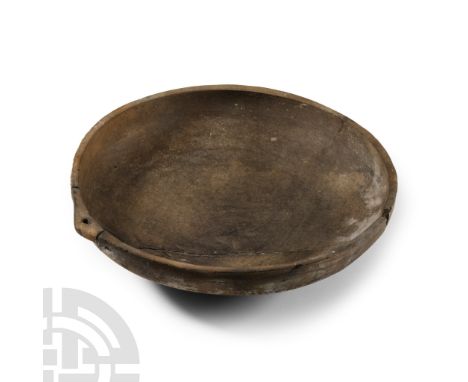 Iron Age, Cypro-Geometric, 950-850 B.C. Broad shallow body with disc base, thick rim with pierced lug handle; repaired. Cf. s