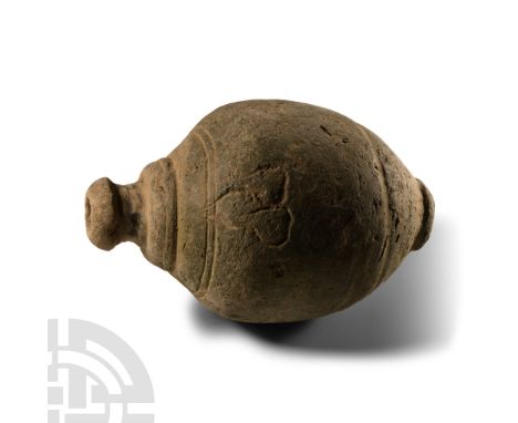 9th-11th century A.D. Piriform body with impressed ivy-leaf motifs below the shoulder, tiered shoulder, domed filler-hole, in