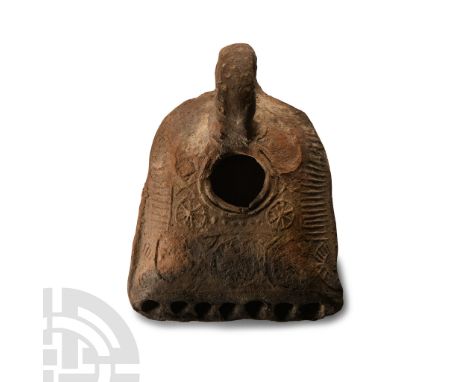 4th-5th century A.D. Hollow-formed tongue-shaped lamp with chamfered sides, loop handle, large filler hole; low-relief rosett