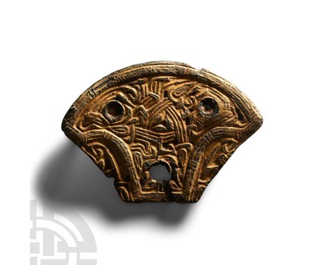 6th-7th century A.D. Comprising a pelta-shaped panel pierced in three places to accept a rivet (one absent); obverse with low