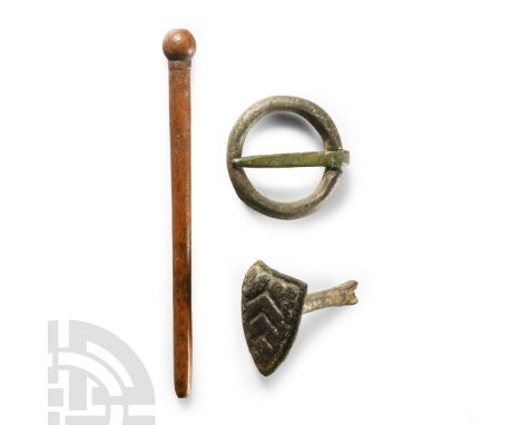 13th-15th century A.D. Comprising: heater shield stud; bone dress pin; ring brooch with pin.  11.37 grams total, 23-66 mm (1 