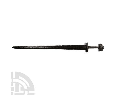 Circa 10th-11th century A.D. With three-lobe pommel and decorated guard; the blade 45mm wide at the upper end, gently taperin