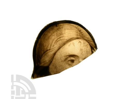 16th-17th century A.D. D-shaped panel with painted detailing of the eye, brow and centre-parted hair.  27 grams, 95 mm (3 3/4