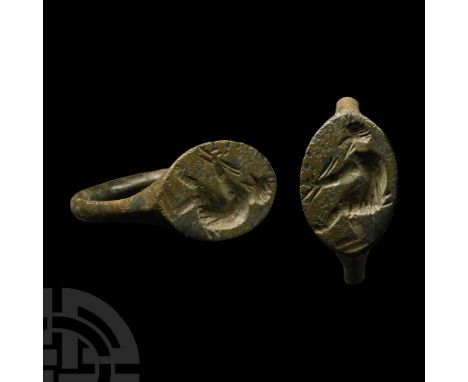 4th-3rd century B.C. With scaphoid bezel, intaglio seated faun with syrinx.  3.55 grams, 20.92 mm overall, 17.06 mm internal 