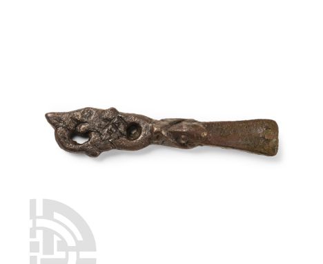 9th-11th century A.D. Comprising an elongated plate with longitudinal split and rivet, animal-head decoration to the narrow e