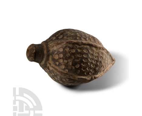 9th-11th century A.D. Piriform body with vertical ribs and impressed roundels across the whole surface, domed filler-hole, in