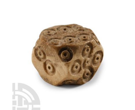 1st-4th century A.D. Cuboid with chamfered corners each with a ring-and-dot motif, reserved pellet marks disposed 1:6, 2:4, 3