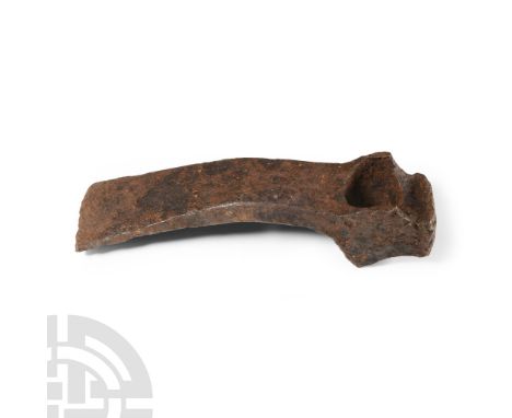 Circa 6th century A.D. Flat-section blade with gently curved cutting edge, round socket with spurs to both edges, clubbed ham