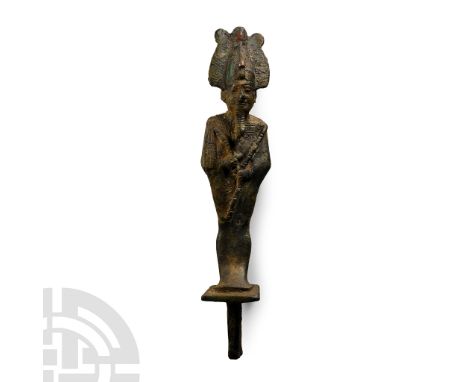 Late Period, 664-525 B.C. Modelled in the round wearing the Atef crown with a uraeus to the brow, arms crossed on the chest h