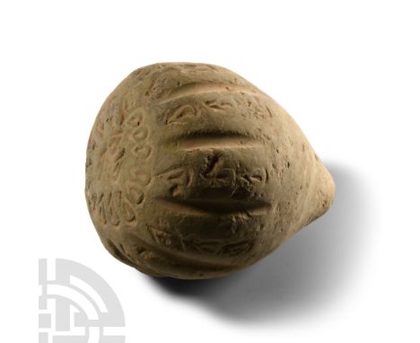 9th-11th century A.D. Piriform body with ribs to the shoulder and impressed ovoids to the upper face, recessed filler-hole to