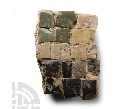 North Africa, 2nd century A.D. With portion of original matrix and five rows of tesserae in grey, black, cream and white. Cf.