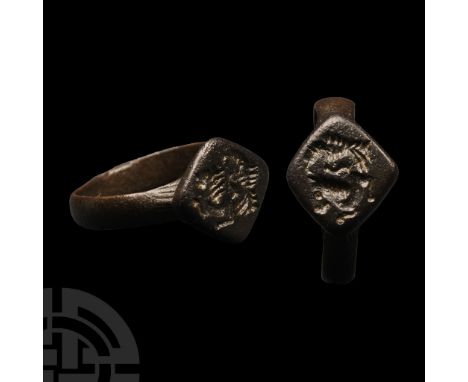 12th-14th century A.D. Lozengiform bezel with intaglio running horse with leaping lion pouncing above.  4.87 grams, 23.58 mm 