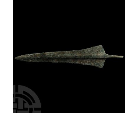 Circa 13th-6th century B.C. With leaf-shaped blade and rounded tip, pronounced medial rib and shoulder flanges, short flat-se