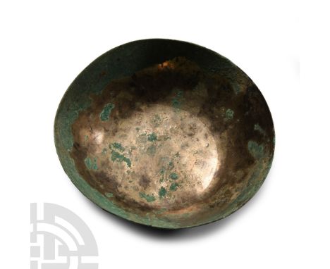Circa 9th-7th century B.C. Raised from a single sheet with slightly convex walls; concentric circles to the inner base with a