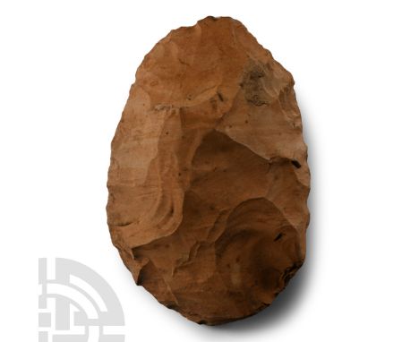 Lower Palaeolithic Period, circa 400,000-200,000 B.P. In light brown stone, of rounded profile with thickened butt; inked col