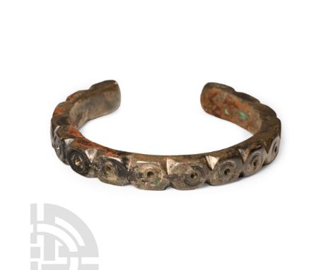 13th-14th century A.D. Comprising a penannular body with segmented ring-and-dot design.  55 grams, 62 mm (2 1/2 in.). UK priv