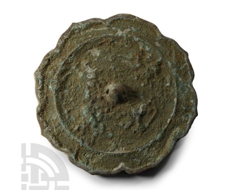 Tang Dynasty, 618-907 A.D. or later. Discoid in plan with dentilled rim and raised ring to the reverse, central pierced dome 