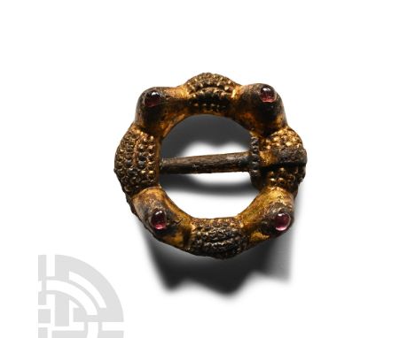 Circa 13th-14th century A.D. Comprising an annular body decorated with four raised pyramidal knops each set with an amethyst 