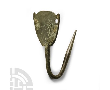 Circa 6th-8th century A.D. Hipped dress pin with slight bulb to the lower shank, D-shaped headplate with lateral spurs to the